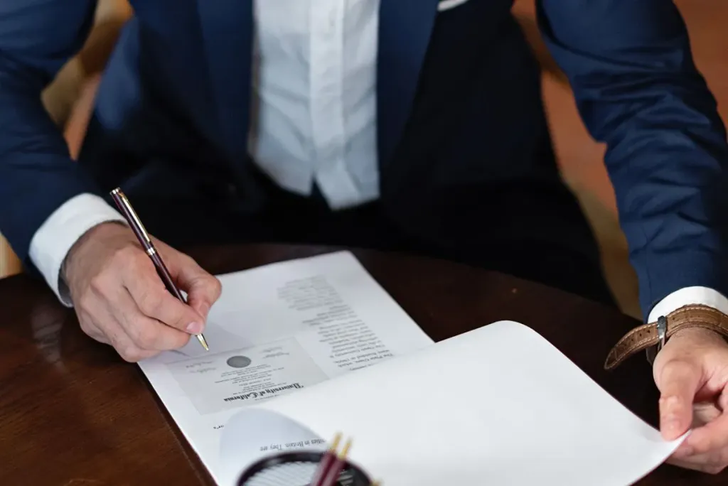 Signing documents at a desk